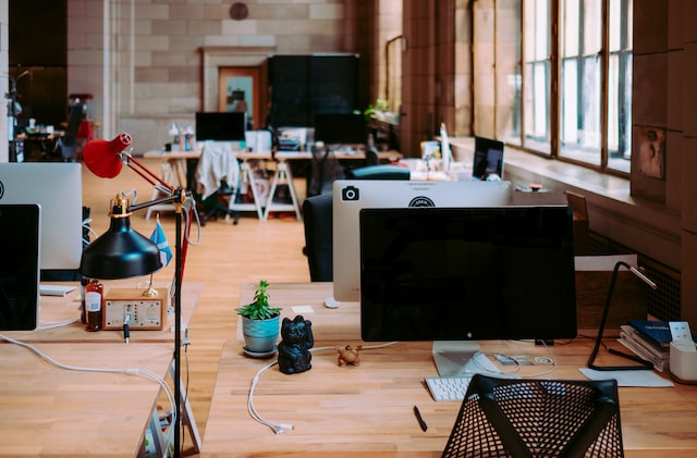 empty office space with a lot of natural light shining through the window