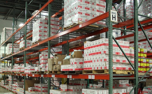 warehouse setting with multiple shelves stocked full of bulk goods