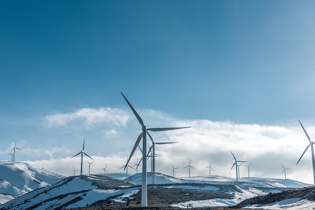 wind turbine farm in a snowy mountain setting