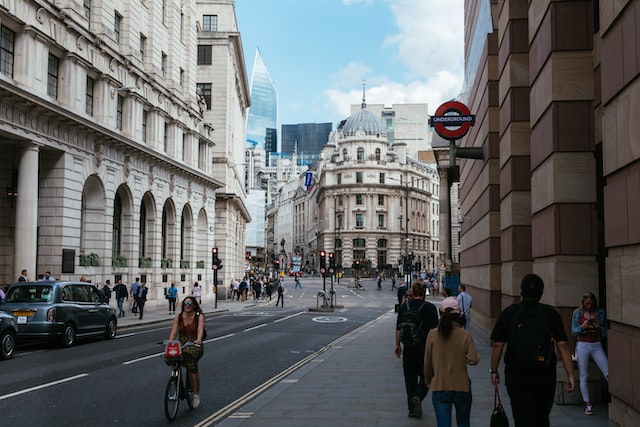 busy junction in the City of London with the entrance to an Underground Tube Station in the foreground