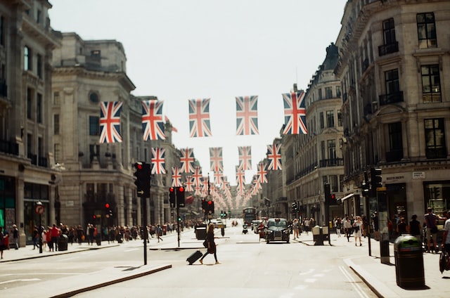 view down a central london street with british flags hanging across buildings