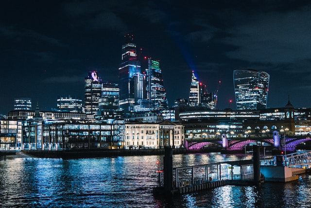 Night view across the River Thames at London City skyline with all its innumerable hot desking and virtual office in London options image at LondonOfficeSpace.com.