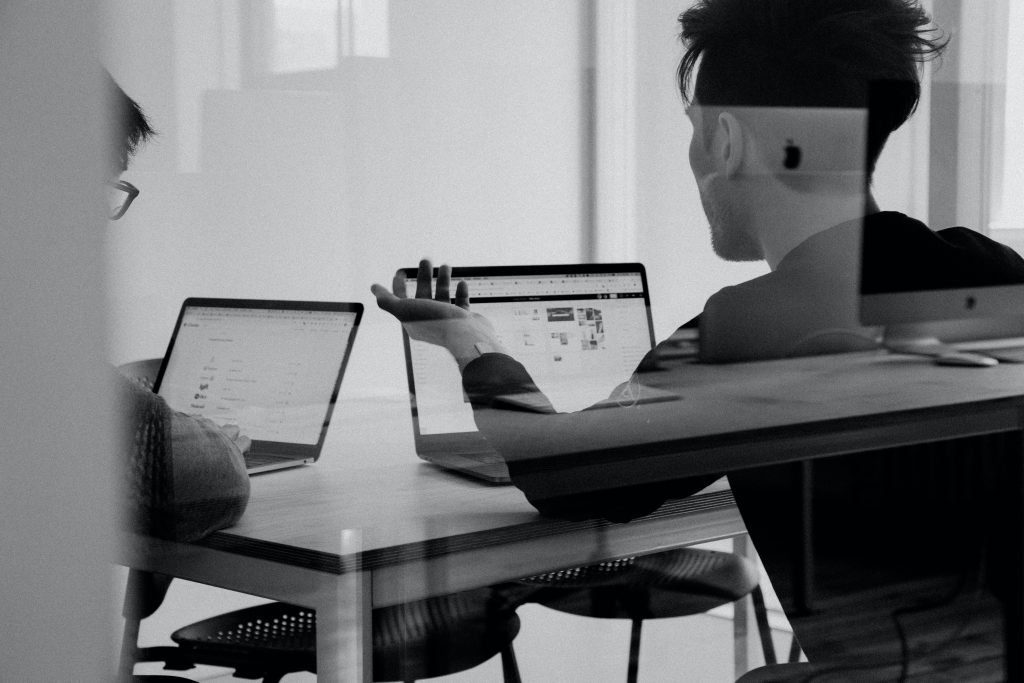 two people in an office behind glass discussing an office lease