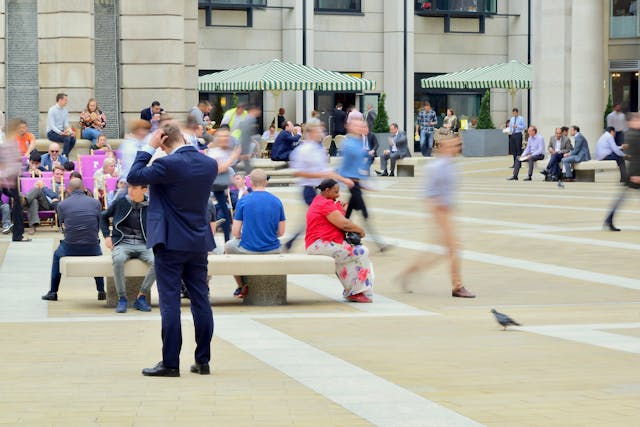 A daytime street view of a bustling Canary Wharf plaza with tourists, businesspeople, and locals all milling about. Image at LondonOfficeSpace.com.