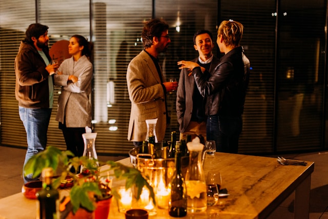 People stand around and mingle happily at an office opening networking event. Image at LondonOfficeSpace.com.
